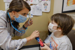 Pediatrician examines a young boy